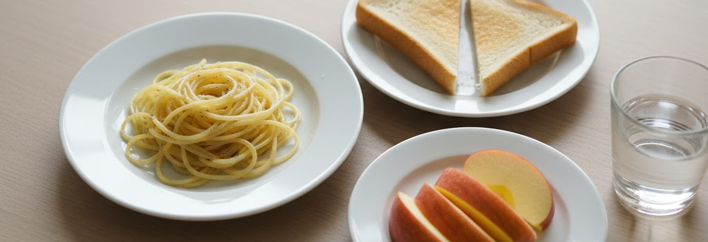 Plain pasta, toast, and apple slices on a table - a typical limited diet for picky eaters